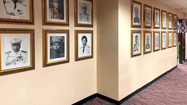 An office hallway hung with framed portraits at the Hmong Village Shopping Center in Saint Paul, Minnesota