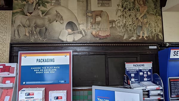 The public lobby of the St Matthew Station post office in San Mateo, California, with painted panels along the wall