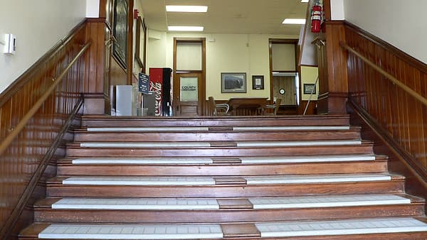 The interior stairs of the Wayne County Courthouse in Wayne, Nebraska, rising from the main entrance