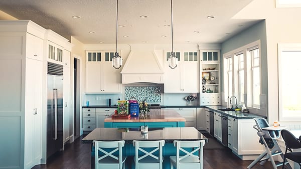 A blue and white kitchen interior in Springville, United States, with the counter clear and the light on