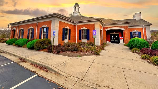 A community bank branch in Hayesville, North Carolina, seen from the road with its sign at the front
